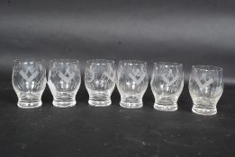 A set of six Masonic firing glasses, engraved with the square and compass, sun,