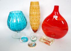 A collection of coloured art glass to include teal brandy glass, large moon flask of two tone form ,