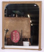 A large Victorian wooden and gilt plaster overmantel mirror.