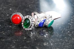 Four white metal (stamped 925 indicating silver) and gem set rings