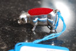 A 925 silver white metal pig shaped pin cushion