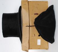 A 1920's Dunn & Co top hat complete in the original box together with a black felt scull cap both