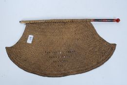 A 19th century Indian rattan hand fan, on original turned wooden pole.