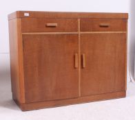 A Heals style 1930's Art Deco oak sideboard having rounded corners featuring 2 short drawers over
