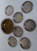 A fab vintage Philips Lamps brass ash tray along with seven silver plated wine bottle coasters.