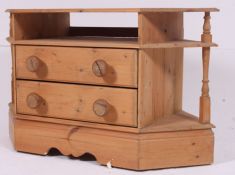 A 20th century contemporary pine tv side cabinet of angular lozenge form having central drawers H62
