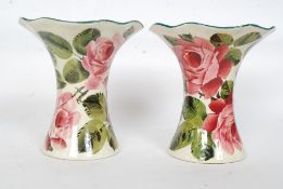 A fabulous pair of ceramic Wemyss pottery flared vase with hand painted rose decoration being