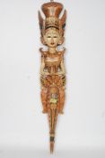 A highly decorated wooden carving of an Asian female deity atop of a dragon possibly Thai /