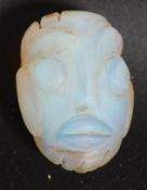 A believed 19th century Polynesian Marquesan Islands / Maori tribal carved glass toggle in the form