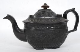 A 19th century black basalt ware Victorian teapot with lid and wooden finial having impressed mark