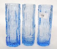 A collection of three whitefriars style blue glass bark effect vases.