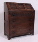 A Jaycee / Old Charm oak bureau writing desk in the Jacobean revival style.