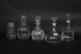 A collection of cut glass decanters to include one with beaker top ,