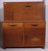 A fabulous 1920's oak school cupboard / cabinet raised on stub tapered supports with cabinet body