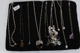 A collection of 8x silver and white metal (and others) costume jewellery necklaces.