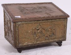 A fabulous early 20th century pressed brass coal purdonium with traditional scenes,