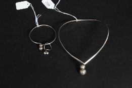 A silver modernist ladies choker necklace, bangle and ring set all being marked Sterling.
