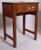 A vintage mid century childs school desk with lift up/ hinged writing surface for storage and ink