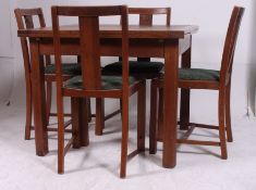A 1930's Art Deco oak draw leaf refectory dining table together with a set of 4 matching oak dining