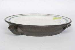 A 19th century pewter and enamel plate warmer with tap