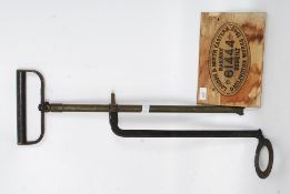 A floor standing Stirrup pump and a vintage style railways sign mounted on a wooden base