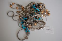A collection of 16 silver and white metal necklaces one being set with turquoise beads and many