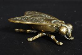 An early 20th century large brass table vesta case in the form of a fly with hinged top to wings