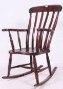 A Victorian beech wood rocking windsor chair having bow sleigh runners, turned legs with stretchers,