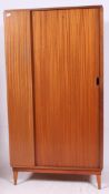 An excellent 1970's solid teak wood single tambour fronted bachelors wardrobe by Austinsuite.