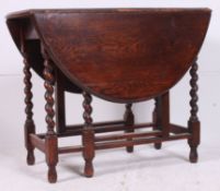 A good quality 20th century carved oak barley twist dining table having drop leaves with gate legs