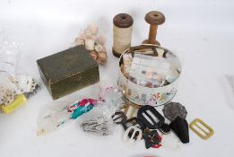 A collection of vintage buttons from the 20th century to include sewing equipment, threads,