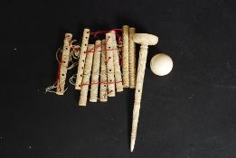A 19th century Chinese Ivory childs ball and cup game being profusely carved with ball and tapering