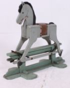 A 1950's scratchbuilt painted wooden rocking horse in grey with saddle and glider base