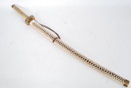 A ornamental Chinese made Samurai sword having a faux snake skin sheaf