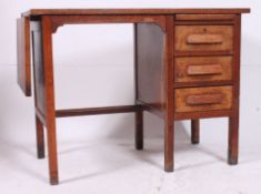 A vintage 1920's solid oak clerks desk having kneehole recess with pedestal bank of drawers.
