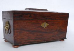 A Georgian rosewood tea caddy box of sarcophagus form having brass lion mask handles to the sides
