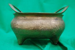 A Chinese twin handled brass cauldron /