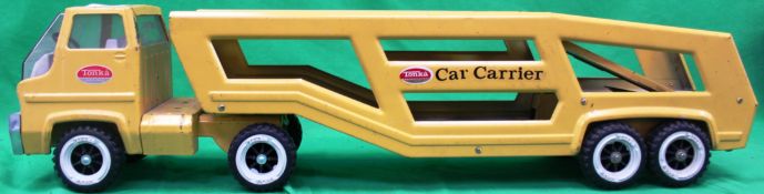 A vintage Tonka car transporter in yello