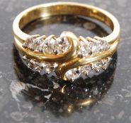 An 18ct yellow gold diamond ring with fabulous swirl gold head surrounded by diamonds.