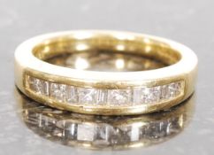 A  ladies 18ct gold and diamond channel set ring. The diamonds approx .50 carat diamonds.