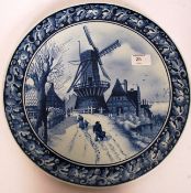 An early 20th century Villeroy & Boch charger with blue and white painted decoration of a village