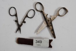 A pair of cruciform scissors  marked Premier Waldsol together with a combination tool scissors