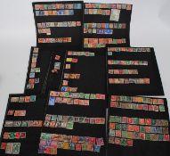 A collection of stamps on black boards to include New Zealand, India, American, Canada, German,