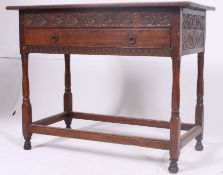 An 18th century peg jointed country oak lowboy table raised on gun barrel supports with stretchers