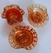 Two Fenton's marigold Carnival Glass baskets together with another example.