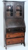 A Victorian Arts & Crafts Liberty manner oak student bureau having bookcase cabinet over bureau