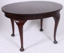 A 1930's mahogany oval extending dining table  all raised on cabriole legs.