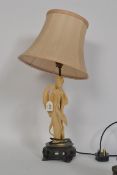 A Chinese resin set table lamp having figurine stem raised on a socle base being recently re-wired