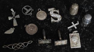 A  collection of silver 925  Sterling items to include thimbles, religious pendants,