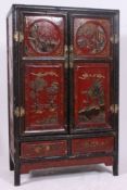 A good 20th century Chinese chinoserie painted laquered marriage cabinet of shaped form with twin